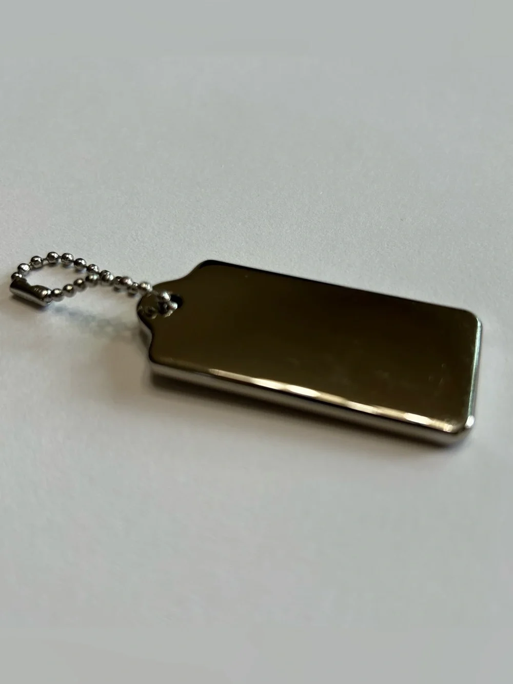 Coach New York silver-tone metal hangtag bag charm